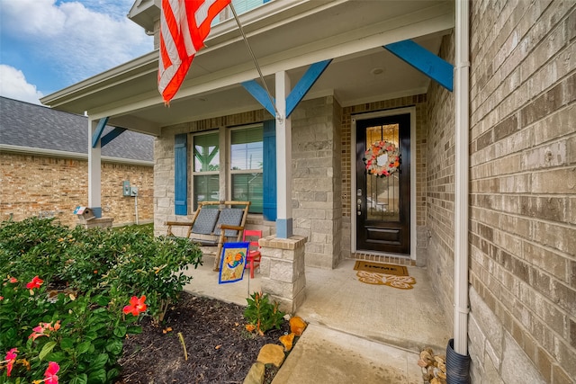 view of exterior entry featuring a porch