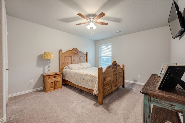 carpeted bedroom featuring a textured ceiling and ceiling fan