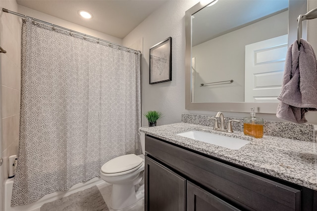 bathroom featuring tile patterned flooring, vanity, and toilet