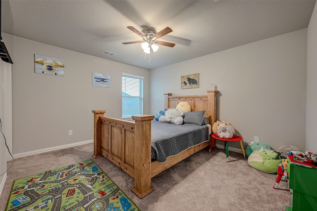 carpeted bedroom with a textured ceiling and ceiling fan