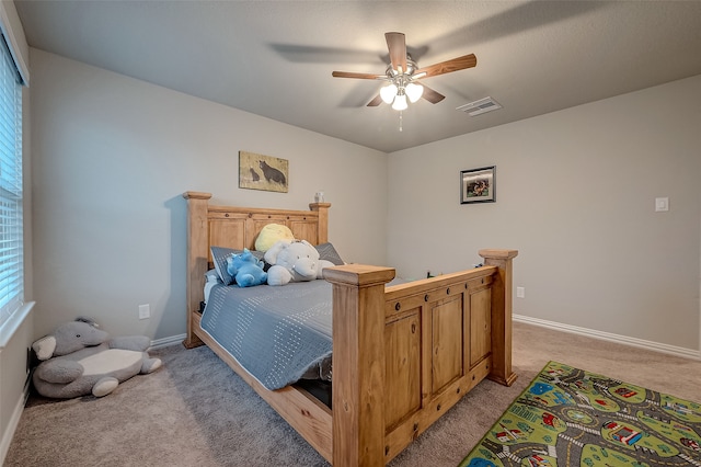 bedroom with ceiling fan and light carpet