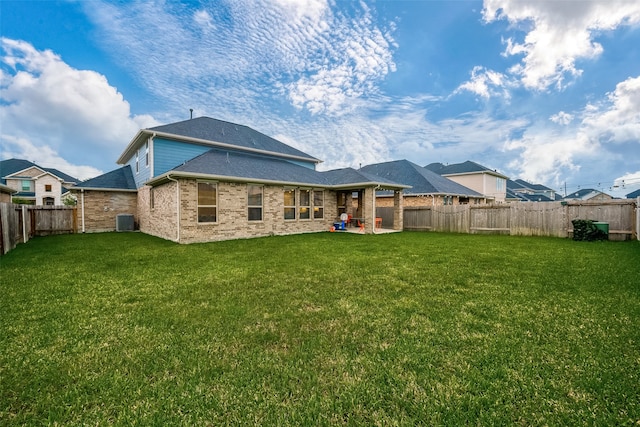 back of property featuring a patio, a yard, and central AC