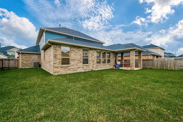 rear view of property featuring central AC, a yard, and a patio