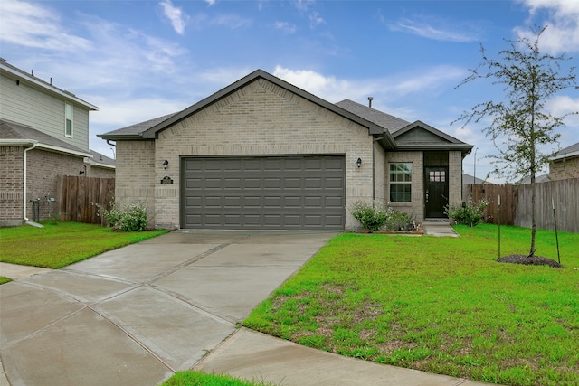 view of front of home featuring a front yard and a garage