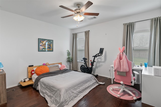 bedroom with dark hardwood / wood-style flooring and ceiling fan