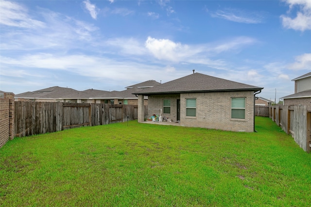 rear view of house featuring a patio area and a lawn