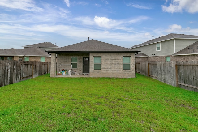 back of property featuring a patio area and a lawn