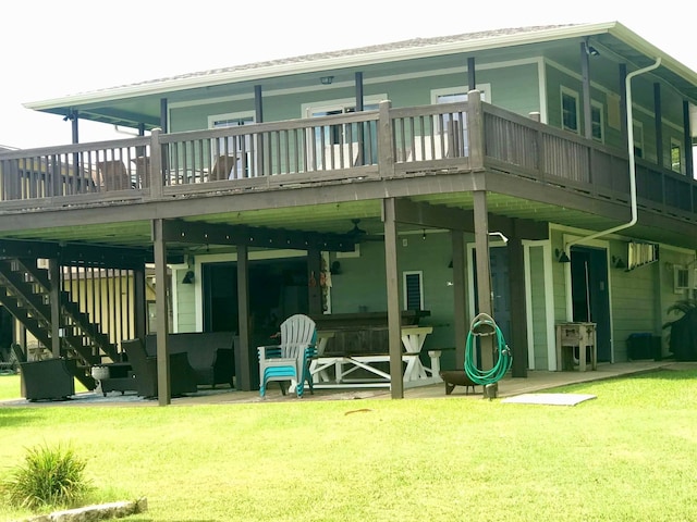 back of house featuring a deck, a yard, and a patio