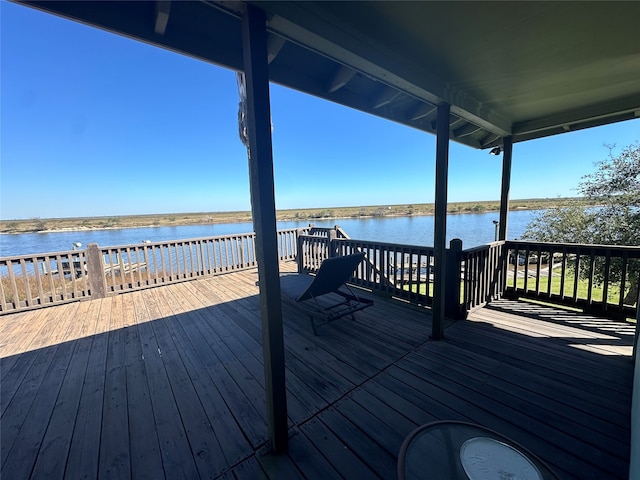 wooden terrace featuring a water view