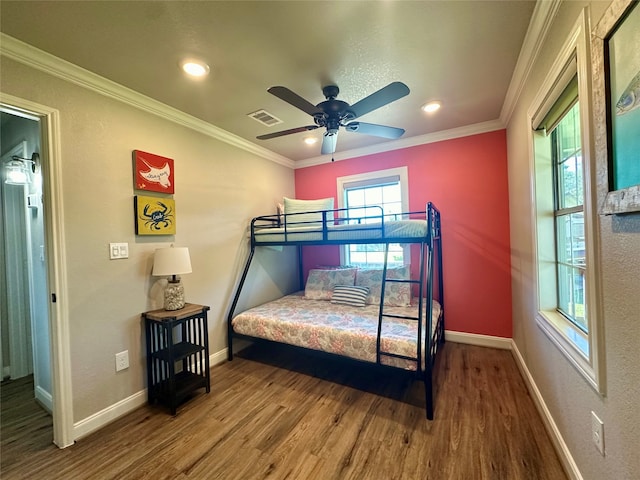 bedroom featuring ceiling fan, wood-type flooring, and ornamental molding