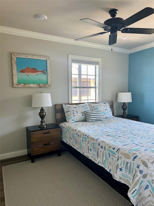 bedroom with hardwood / wood-style floors, ceiling fan, and ornamental molding