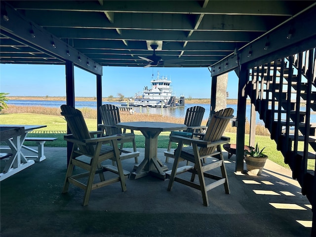 view of patio with a water view