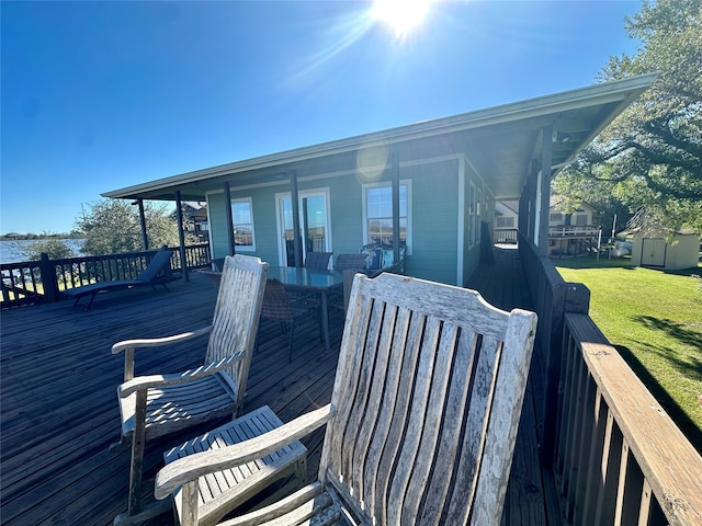 deck with a yard and a shed