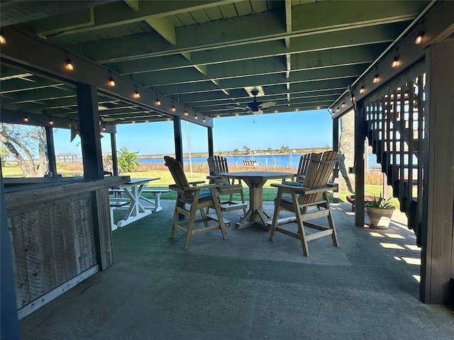 view of patio / terrace with a water view and ceiling fan