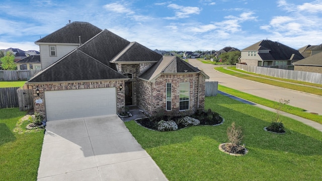 view of front of home featuring a front yard and a garage