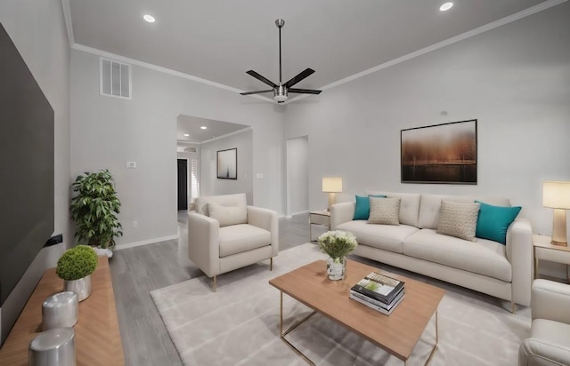 living room featuring ceiling fan, light wood-type flooring, and crown molding