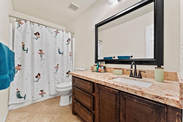 bathroom featuring vanity, tile patterned flooring, a textured ceiling, and toilet