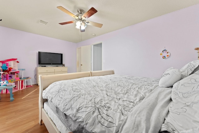 bedroom with hardwood / wood-style floors and ceiling fan