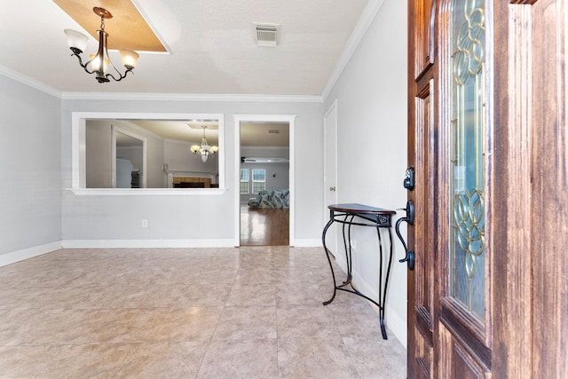 entryway featuring ornamental molding, a notable chandelier, and a textured ceiling