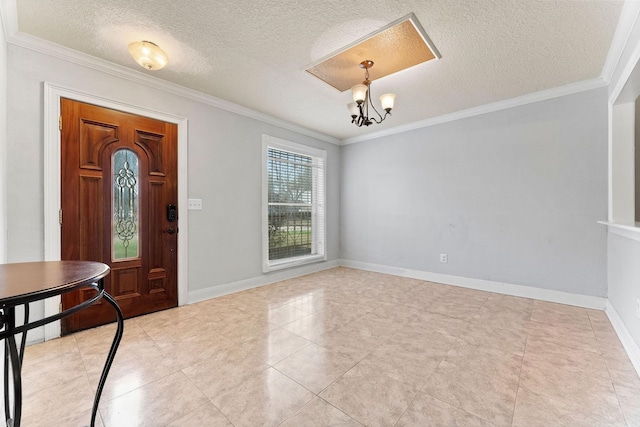 foyer entrance featuring a notable chandelier, a textured ceiling, and crown molding