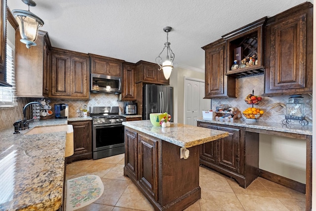 kitchen featuring appliances with stainless steel finishes, dark brown cabinetry, and a center island