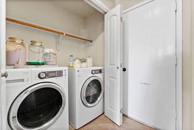 laundry area with washer and dryer and light tile patterned flooring