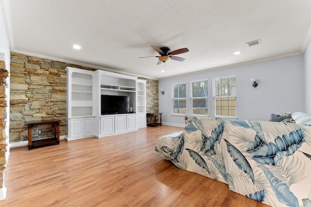 bedroom featuring light wood-type flooring, a textured ceiling, ceiling fan, and crown molding