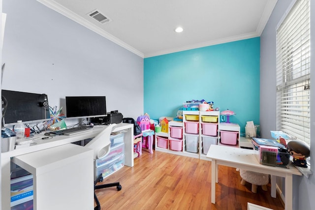 office area with light hardwood / wood-style floors and crown molding