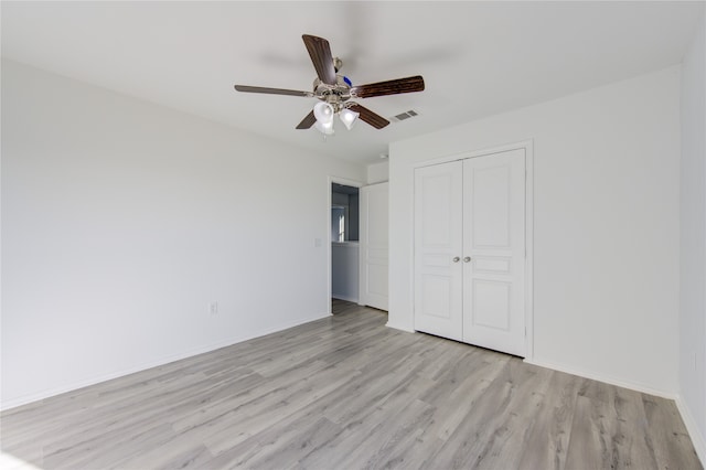 unfurnished bedroom with a closet, ceiling fan, and light hardwood / wood-style flooring