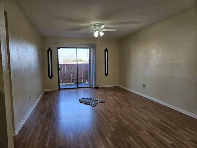 unfurnished room with dark wood-type flooring and ceiling fan