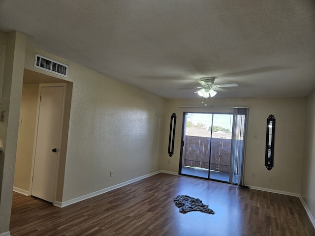 unfurnished room featuring a textured ceiling, ceiling fan, and dark hardwood / wood-style flooring