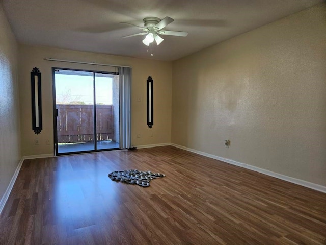 empty room featuring ceiling fan and dark wood-type flooring