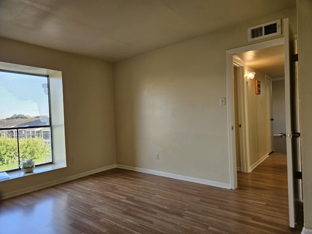 empty room with dark hardwood / wood-style floors