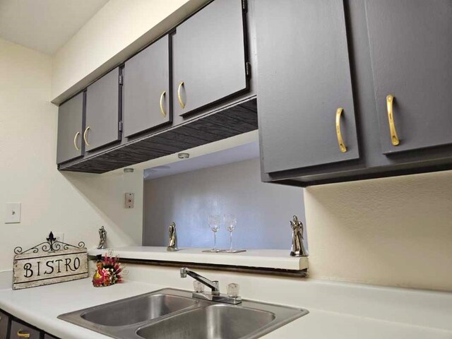 kitchen featuring sink and gray cabinetry