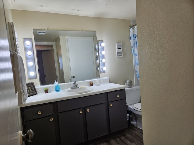 bathroom with vanity, toilet, and hardwood / wood-style floors