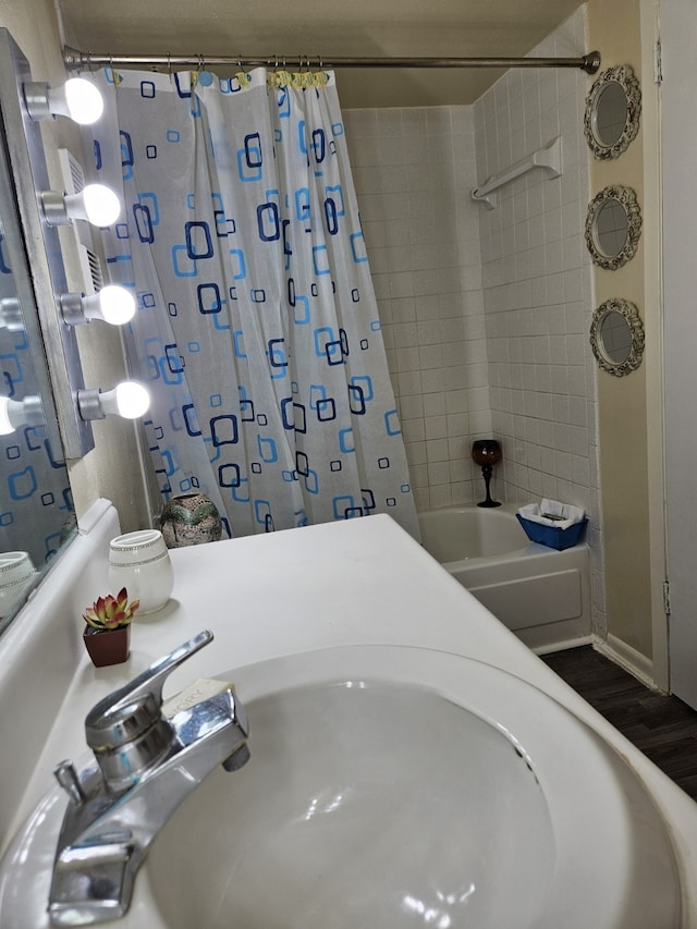 bathroom featuring sink, hardwood / wood-style floors, and shower / bath combo with shower curtain