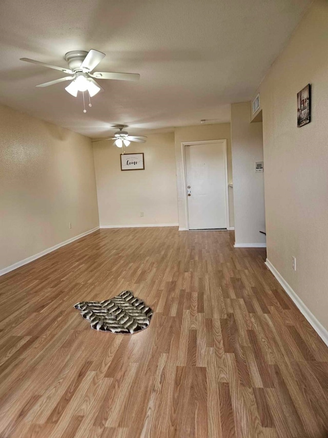 unfurnished room featuring hardwood / wood-style floors and ceiling fan