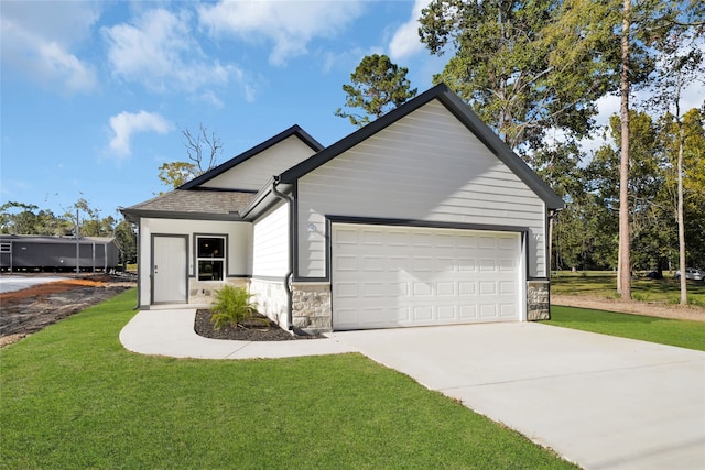 ranch-style house featuring a garage and a front lawn