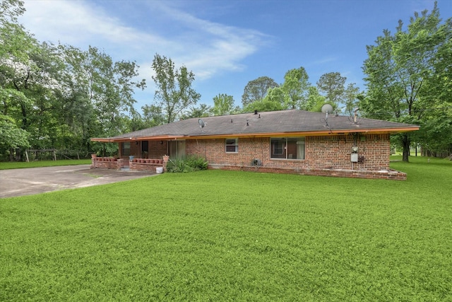 rear view of property with a patio and a yard