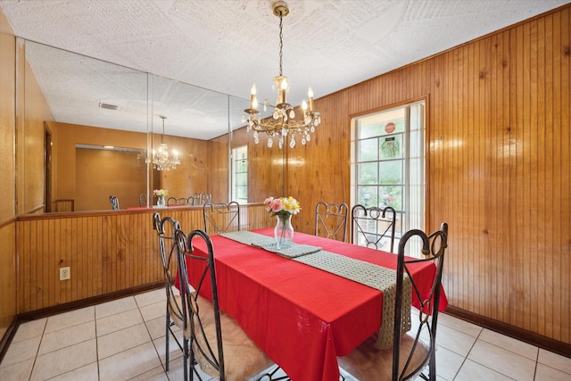 1631 Gault Rd, Houston, TX 77039 - dining area featuring light tile patterned floors, wooden walls, an inviting chandelier, and a wealth of natural light