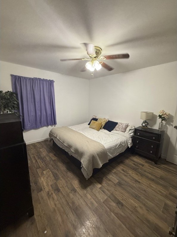 bedroom featuring ceiling fan and wood finished floors