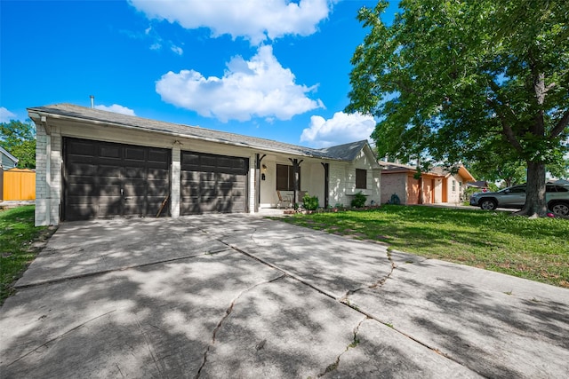 515 Cappamore St, Houston, TX 77013 - ranch-style home with a front lawn, a garage, concrete driveway, and brick siding