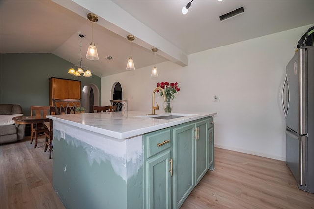 515 Cappamore St, Houston, TX 77013 - kitchen with a sink, freestanding refrigerator, arched walkways, light wood-type flooring, and vaulted ceiling