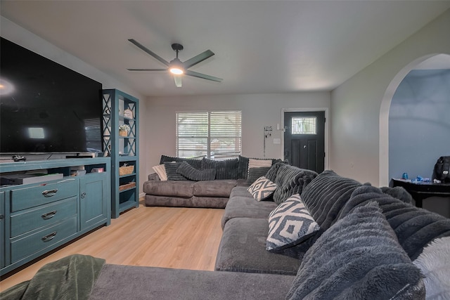 515 Cappamore St, Houston, TX 77013 - living area with arched walkways, ceiling fan, and light wood-style flooring