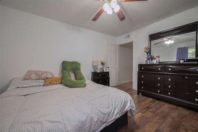 515 Cappamore St, Houston, TX 77013 - bedroom with dark wood-style flooring, a ceiling fan, and baseboards