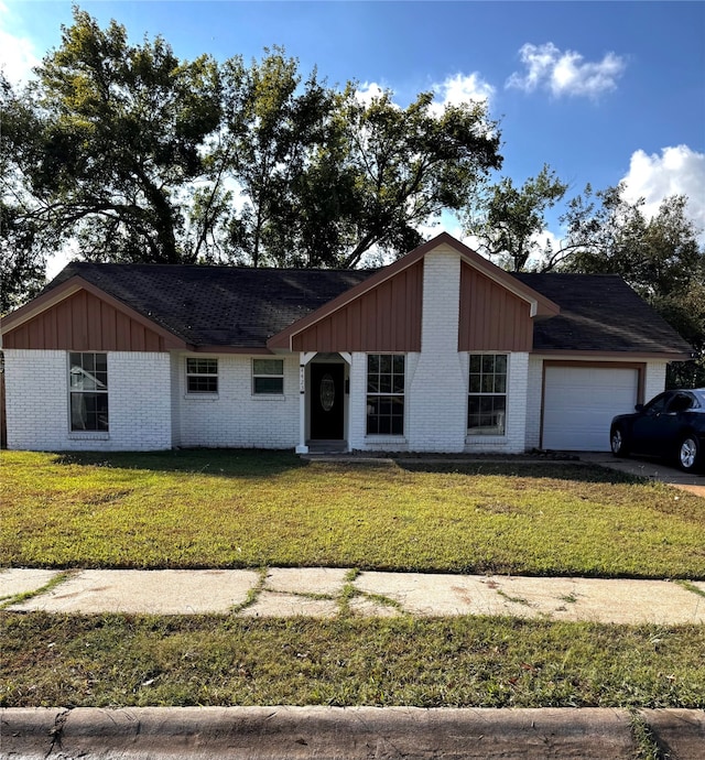 single story home with a front yard and a garage