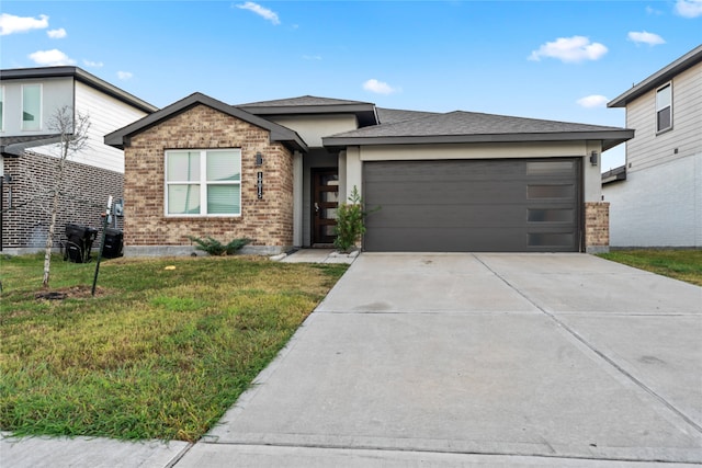 view of front of property with a front yard and a garage