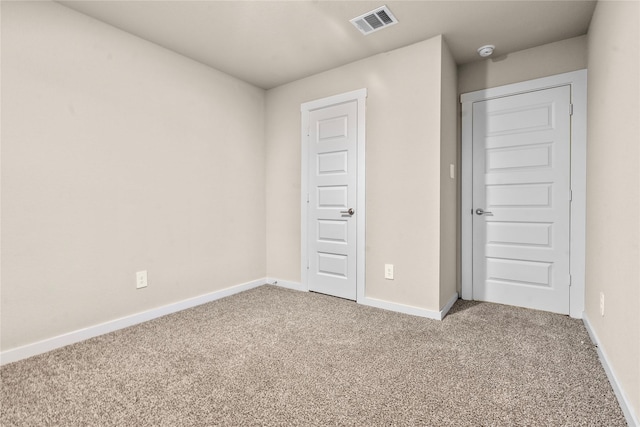 unfurnished bedroom featuring carpet flooring and a closet