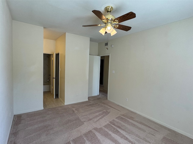 carpeted spare room with ceiling fan