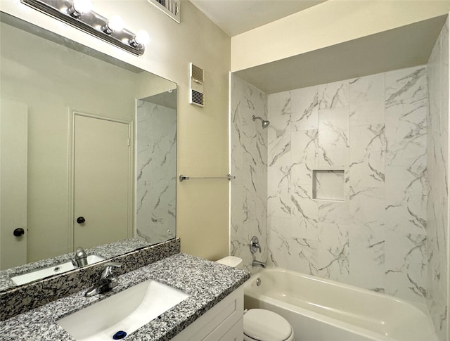 full bathroom featuring toilet, tiled shower / bath, and vanity